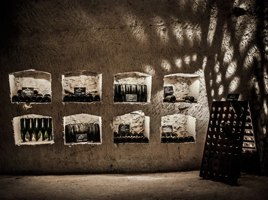 Wine in champagne chalk cellar in illuminated alcoves